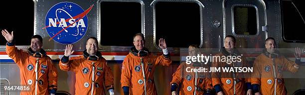 The crew of the space shuttle Endeavour STS-130 wave as they pose in front of the astrovan at Kennedy Space Center in Florida on February 7, 2010 in...