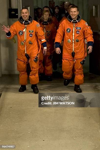 Commander George Zamka waves as the crew of the space shuttle Endeavour STS-130 walk out to the astrovan at Kennedy Space Center in Florida on...