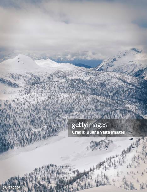 snow covered valley among mountains - be boundless summit stock pictures, royalty-free photos & images