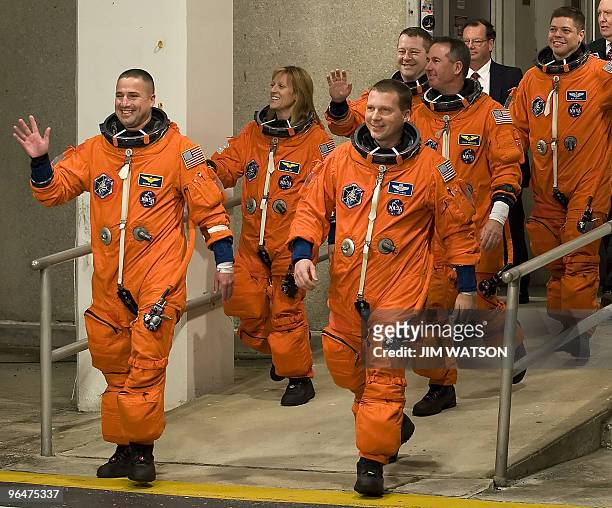 The crew of the space shuttle Endeavour STS-130 wave as they walk out to the astrovan at Kennedy Space Center in Florida on February 7, 2010 in...