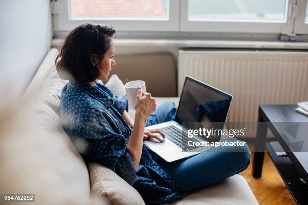 cropped image of woman using laptop with blank screen - computer screen over shoulder stock pictures, royalty-free photos & images