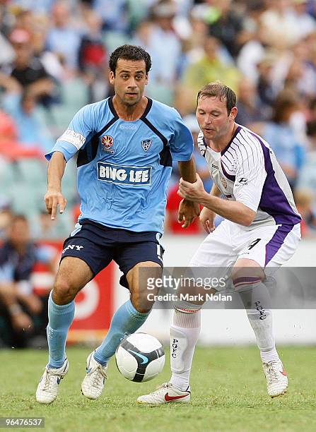 Alex Brosque of Sydney is held off the ball by Steven McGarry of Perth during the round 26 A-League match between Sydney FC and the Perth Glory at...