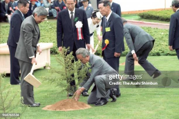 Emperor Akihito and Empress Michiko plant young trees during the 40th National Tree Planting Festival at Kamiyama Forest Park on May 21, 1989 in...