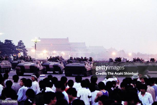 Chinese Army tanks enter Tiananmen Square where is packed with protesting students on June 4, 1989 in Beijing, China.