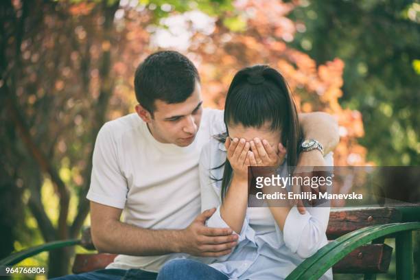 young man supporting female friend - grief loss stock pictures, royalty-free photos & images