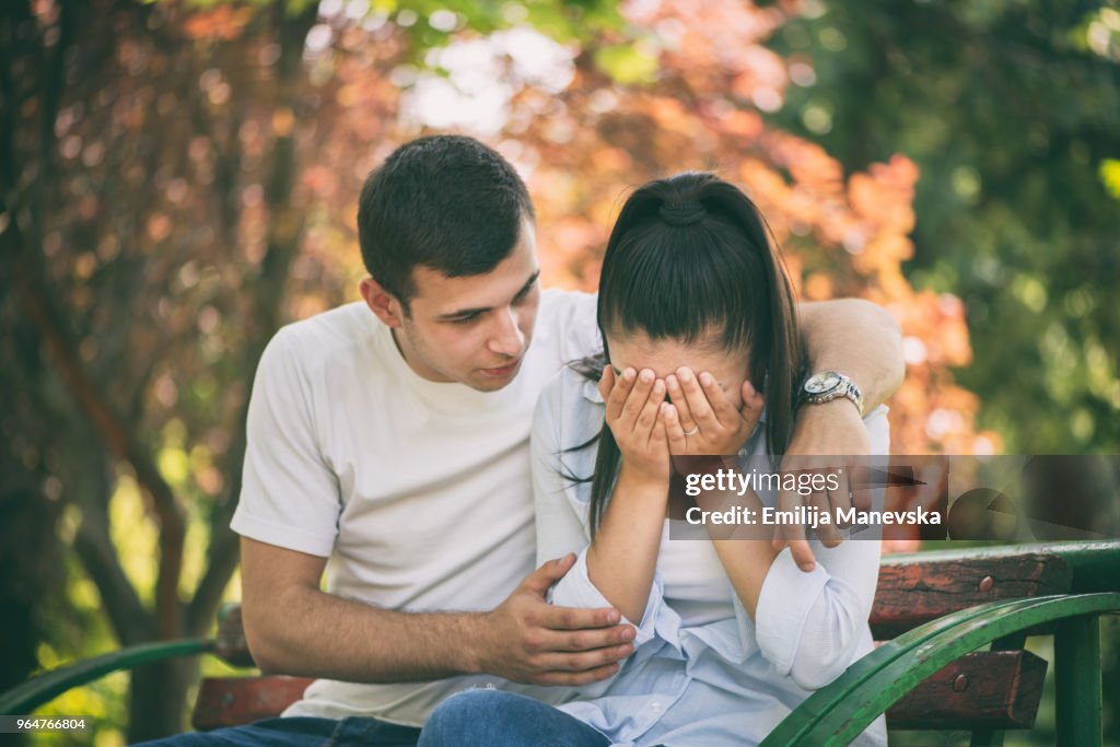 Young man supporting female friend