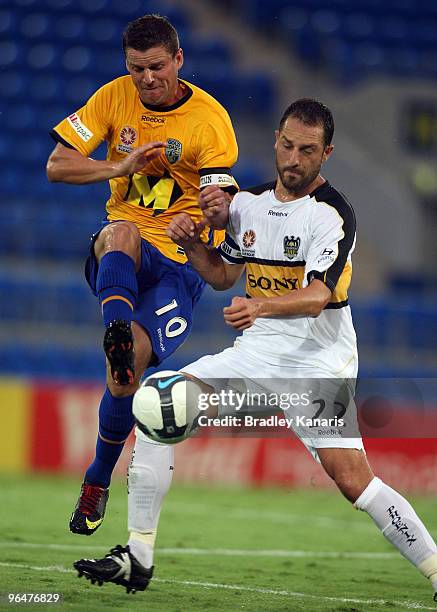 Jason Culina of the Gold Coast and Andrew Durante of the Phoenix compete for the ball during the round 26 A-League match between Gold Coast United...