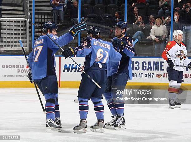 Maxim Afinogenov of the Atlanta Thrashers is congratulated by Pavel Kubina and Nik Antropov after scoring against the Florida Panthers at Philips...