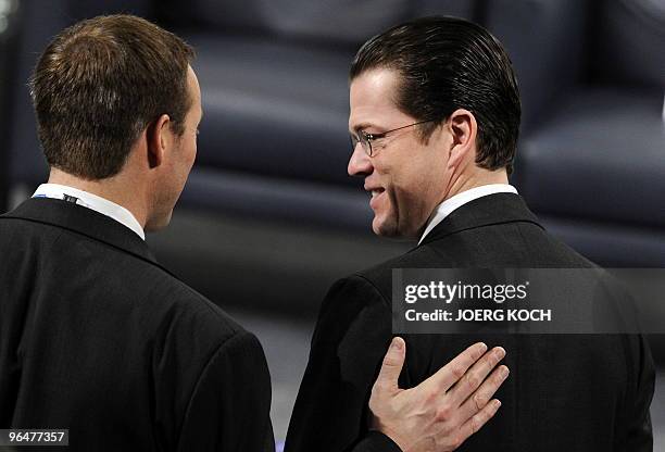 Canada's Defence Minister Peter MacKay speaks with German Defence Minister Karl-Theodor zu Guttenberg prior to a panel discussion on the future of...