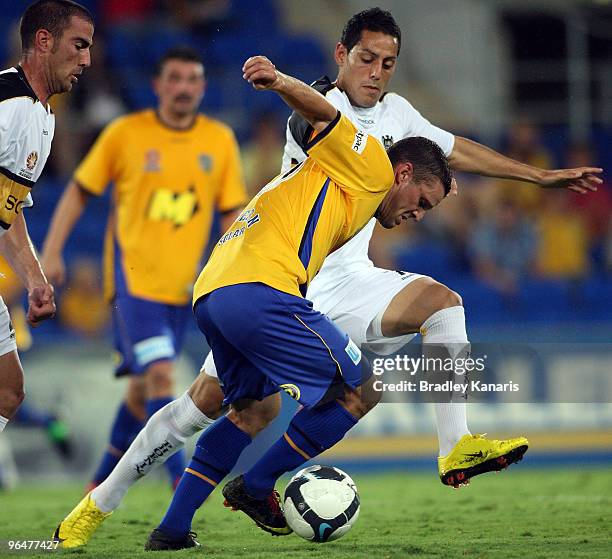 Jason Culina of the Gold Coast is challenged by Leo Bertos of the Phoenix during the round 26 A-League match between Gold Coast United and Wellington...
