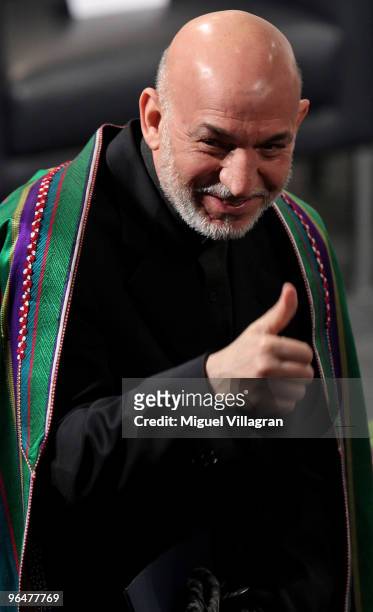 Afghan President Hamid Karzai gives a thumb up during the 46th Munich Security Conference at the Bayerischer Hof hotel in Munich on February 7, 2010...