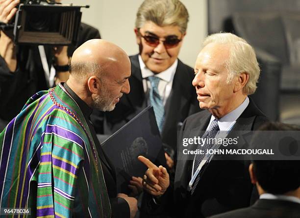 Afghan President Hamid Karzai speaks with US senator Joseph Lieberman prior to a panel discussion on Afghanistan at the 46th Munich Security...