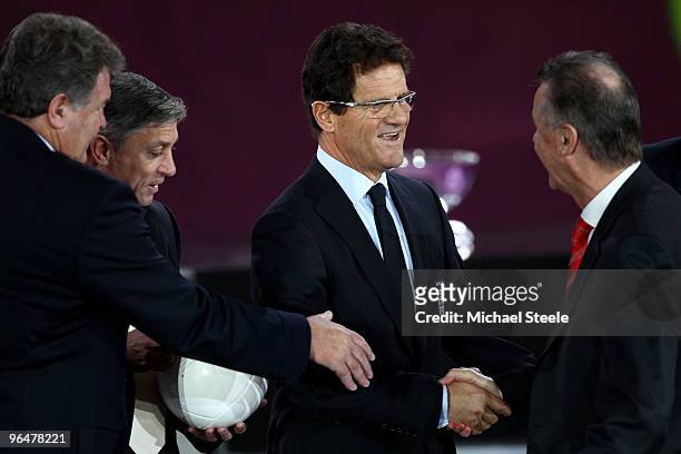 England football coach Fabio Capello shakes hands with Ottmar Hitzfeld coach of Switzerland alongside John Toshack coach of Wales and Zlatko Kranjcar...
