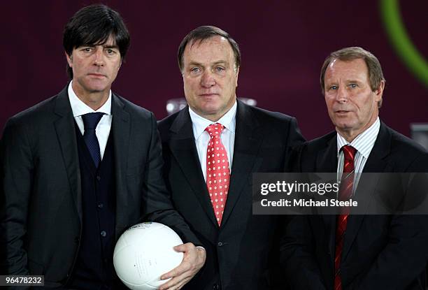 Joachim Low coach of Germany, Dick Advocaat coach of Belgium and Berti Vogts coach of Azerbaijan pose after being drawn in Group A during the...