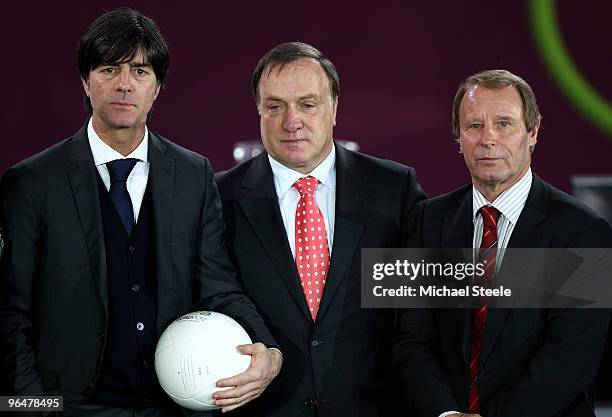 Joachim Low coach of Germany, Dick Advocaat coach of Belgium and Berti Vogts coach of Azerbaijan pose after being drawn in Group A during the...
