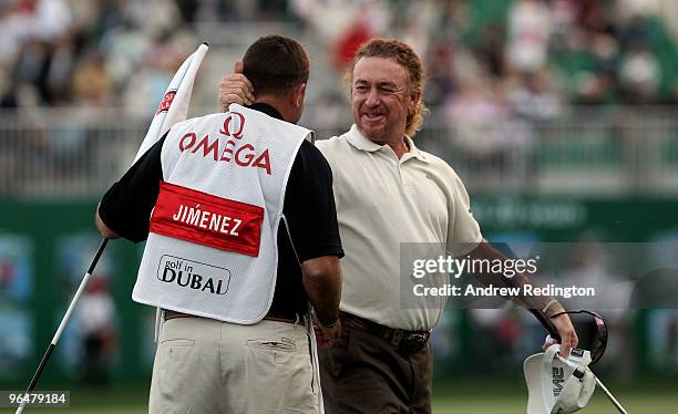 Miguel Angel Jimenez of Spain celebrates with his caddie on the third play-off hole after winning the Omega Dubai Desert Classic on February 7, 2010...