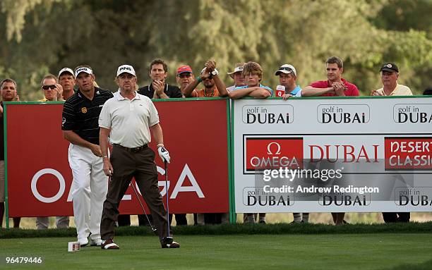 Miguel Angel Jimenez of Spain and Lee Westwood of England stand together on the first play-off hole after winning the Omega Dubai Desert Classic on...