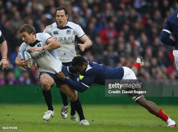 Fulgence Ouedraogo of France tackles Chris Cusiter of Scotland during the RBS Six Nations Championship match between Scotland and France at...