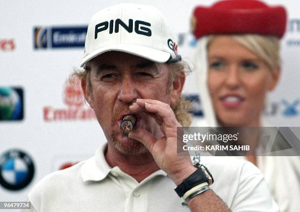 Spain's Miguel Angel Jimenez smokes a cigar after winning the Dubai Desert Classic golf championship in the Gulf emirate on February 7, 2010. Jimenez...