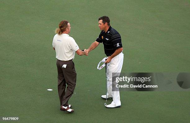 Miguel Angel Jimenez of Spain shakes hands with Lee Westwood of England after his win at the 3rd play-off hole on the 9th green during the final...