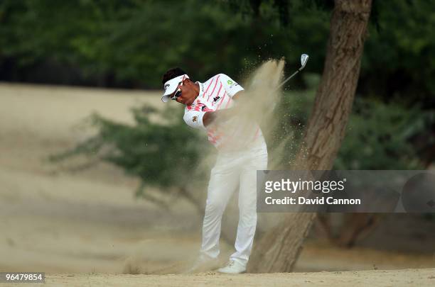 Thongchai Jaidee of Thailand plays his second shot at the 14th hole during the final round of the 2010 Omega Dubai Desert Classic on the Majilis...