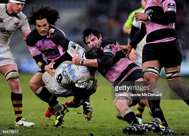 Mark Robinson of Wasps is tackled by Brent Wilson and Tane Tu'ipulotu of Newcastle during the LV Anglo Welsh Cup match between Newcastle Falcons and...