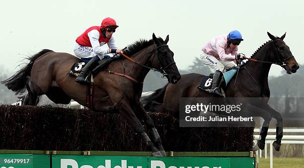 Alain Cawley and Joncol clear an ealy fence in company with the Andrew Lynch ridden Notre Pere before landing The Hennessy Gold Cop Steeplechase Race...