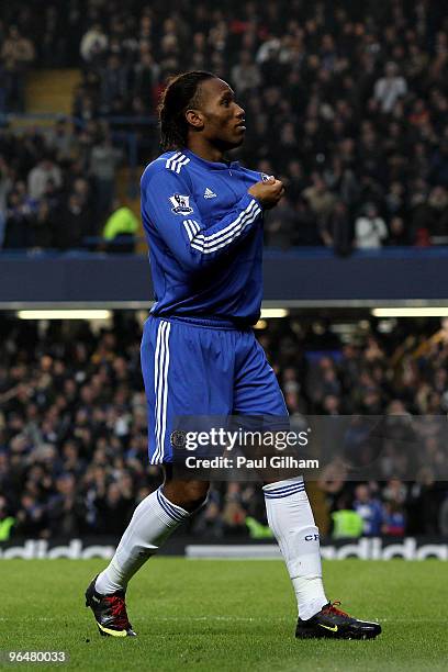 Didier Drogba of Chelsea celebrates scoring the first goal of the game by kissing his badge during the Barclays Premier League match between Chelsea...