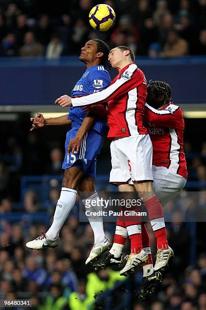 Florent Malouda of Chelsea and Thomas Vermaelen and Bacary Sagna of Arsenal battle for the header during the Barclays Premier League match between...