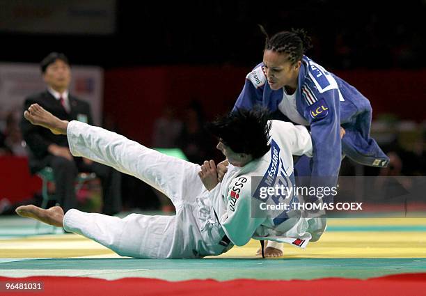 French Lucie Decosse competes with Hungarian Anett Meszaros during their women final round fight, in the under 70kg category, at the Paris judo...