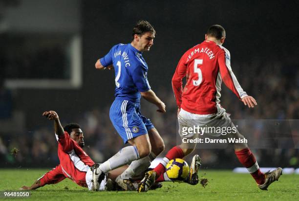 Branislav Ivanovic of Chelsea is tackled by Abou Diaby of Arsenal as Thomas Vermaelen of Arsenal closes him down during the Barclays Premier League...