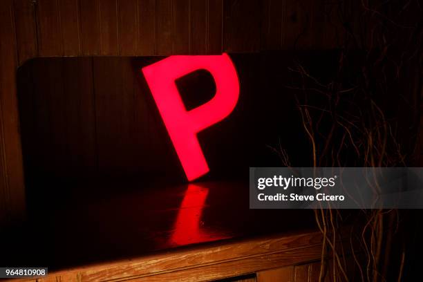 electric capital letter p glowing on counter - p stock pictures, royalty-free photos & images