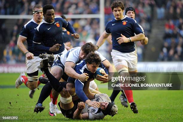 France's center Yannick Jauzion vies with Scotland's flanker Kelly Brown and hooker Ross Ford as France's Imanol Harinordoquy, Fulgence Ouedraogo and...
