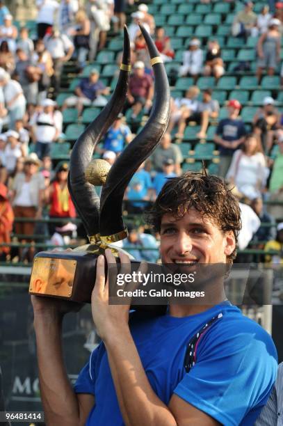 Feliciano Lopez of Spain lifts the winner trophy after winning the Men's Singles Final against Stephane Robert of France during day 7 of the 2010...