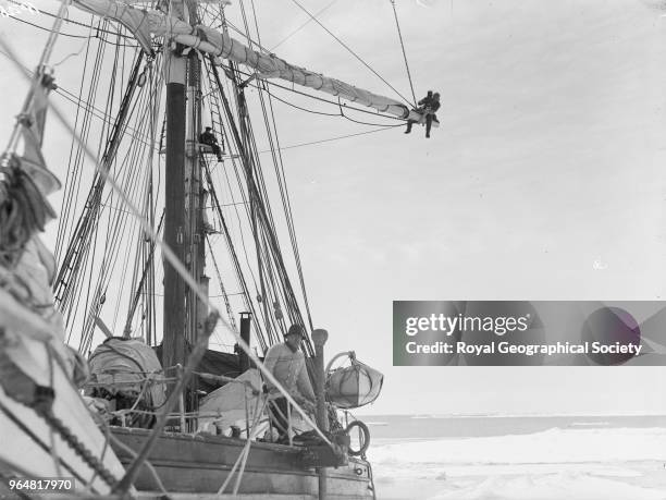 Frank Hurley aloft, Ernest Shackleton on deck of the Endurance, Antarctica, 1914. Imperial Trans-Antarctic Expedition 1914-1916 .