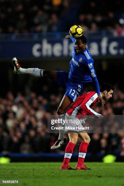 John Mikel Obi of Chelsea beats Cesc Fabregas of Arsenal to the header during the Barclays Premier League match between Chelsea and Arsenal at...