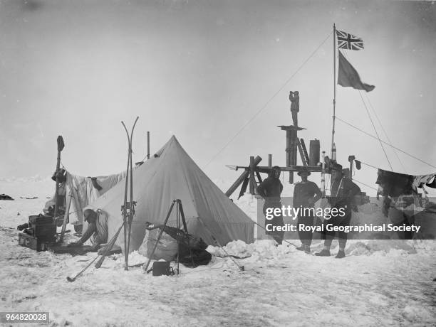 Ernest Shackleton and Frank Wild at Ocean Camp, With the 'Lookout' flying the King's flag and the ship's burgee, Antarctica, December 1915. Imperial...