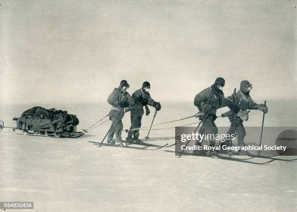 On the Polar Plateau - Evans, Oates, Wilson, Scott on skis and pulling a sledge, Antarctica, 1912. British Antarctic Expedition 1910-1913.