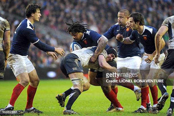 France's winger Mathieu Bastareaud is tackled by Scotland's flanker Kelly Brown during their 6 nations' match Scotland vs France at the Murrayfield...