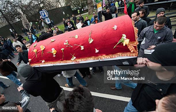 Shiite Muslim devotees carry a coffin in remembrance of Imam Husain martyrdom during the 29th Arbaeen Procession on February 7, 2010 in London,...