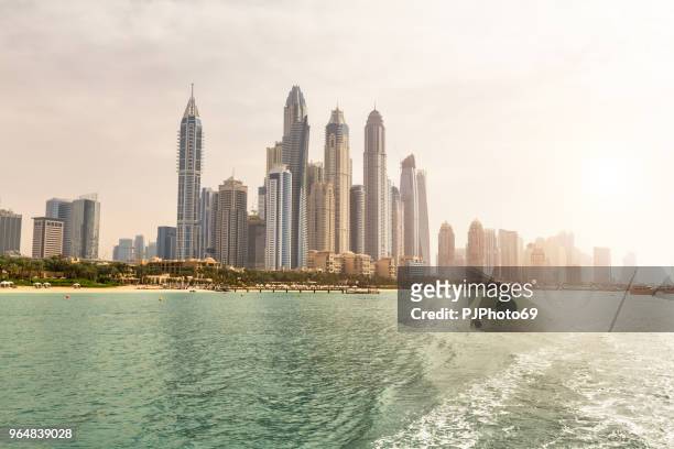 panoramic view of dubai from sea at sunset during a cruise - pjphoto69 stock pictures, royalty-free photos & images