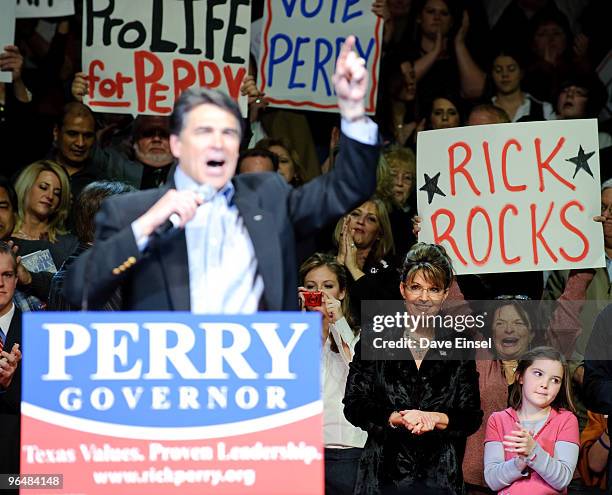 Former Alaska Gov. Sarah Palin and her daughter Piper Palin watch Texas Gov. Rick Perry during a campaign rally for Perry February 7, 2010 in...
