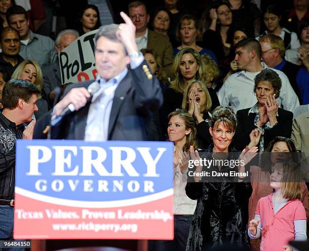 Former Alaska Gov. Sarah Palin reacts to a comment made by Texas Gov. Rick Perry during a campaign rally for Perry February 7, 2010 in Cypress,...