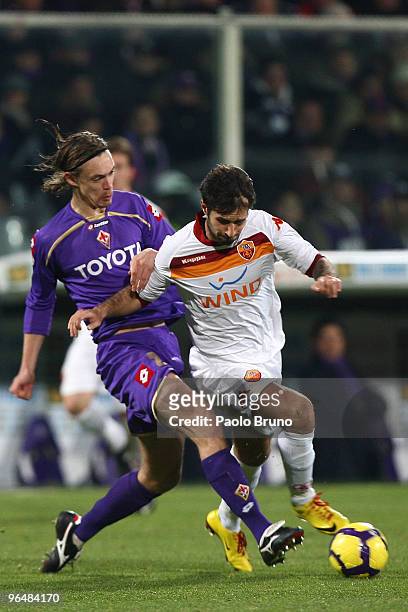 Mirko Vucinic of AS Roma and Pell Billeskov Kroldrup of ACF Fiorentina in action during the Serie A match between Fiorentina and Roma at Stadio...