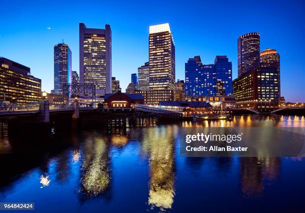 skyline of the waterfront of fort point channel near boston harbour illuminated at dusk - fort point channel foto e immagini stock