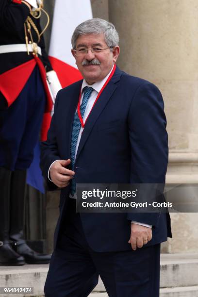 French President Emmanuel Macron welcomes Algeria Prime Minister Ahmed Ouyahia upon his arrival at the Elysee Palace for the international congress...
