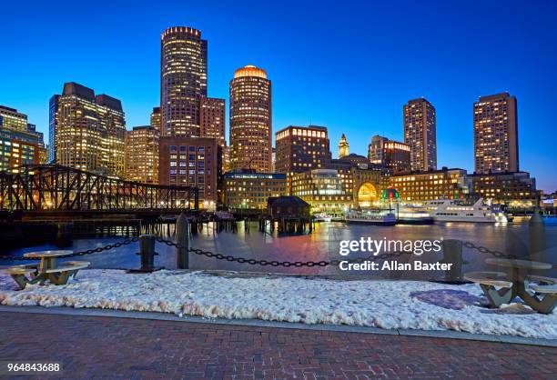 boston harbour and waterfront illuminated at dusk - boston harbour stock pictures, royalty-free photos & images