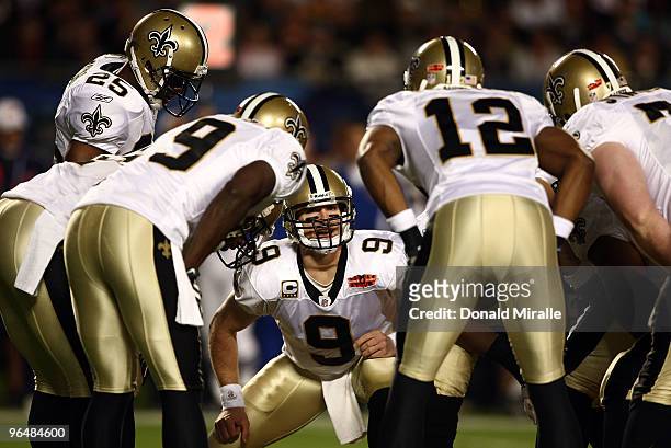 Quarterback Drew Brees of the New Orleans Saints huddles with his team against the Indianapolis Colts during Super Bowl XLIV on February 7, 2010 at...