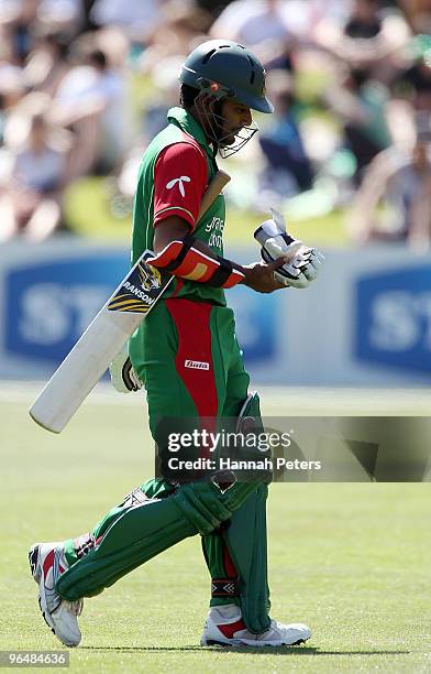 Imrul Kayes of Bangladesh walks off after being run out by Martin Guptill of New Zealand during the second One Day International Match between New...