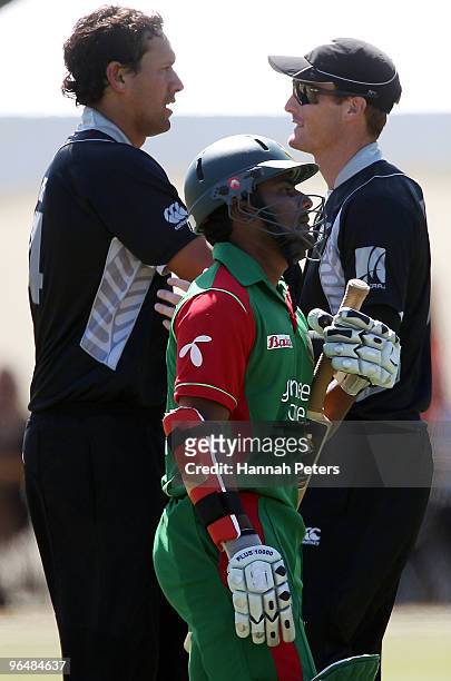 Daryl Tuffey of New Zealand and team mate Martin Guptill celebrate the run out of Imrul Kayes of Bangladesh as he walks off during the second One Day...